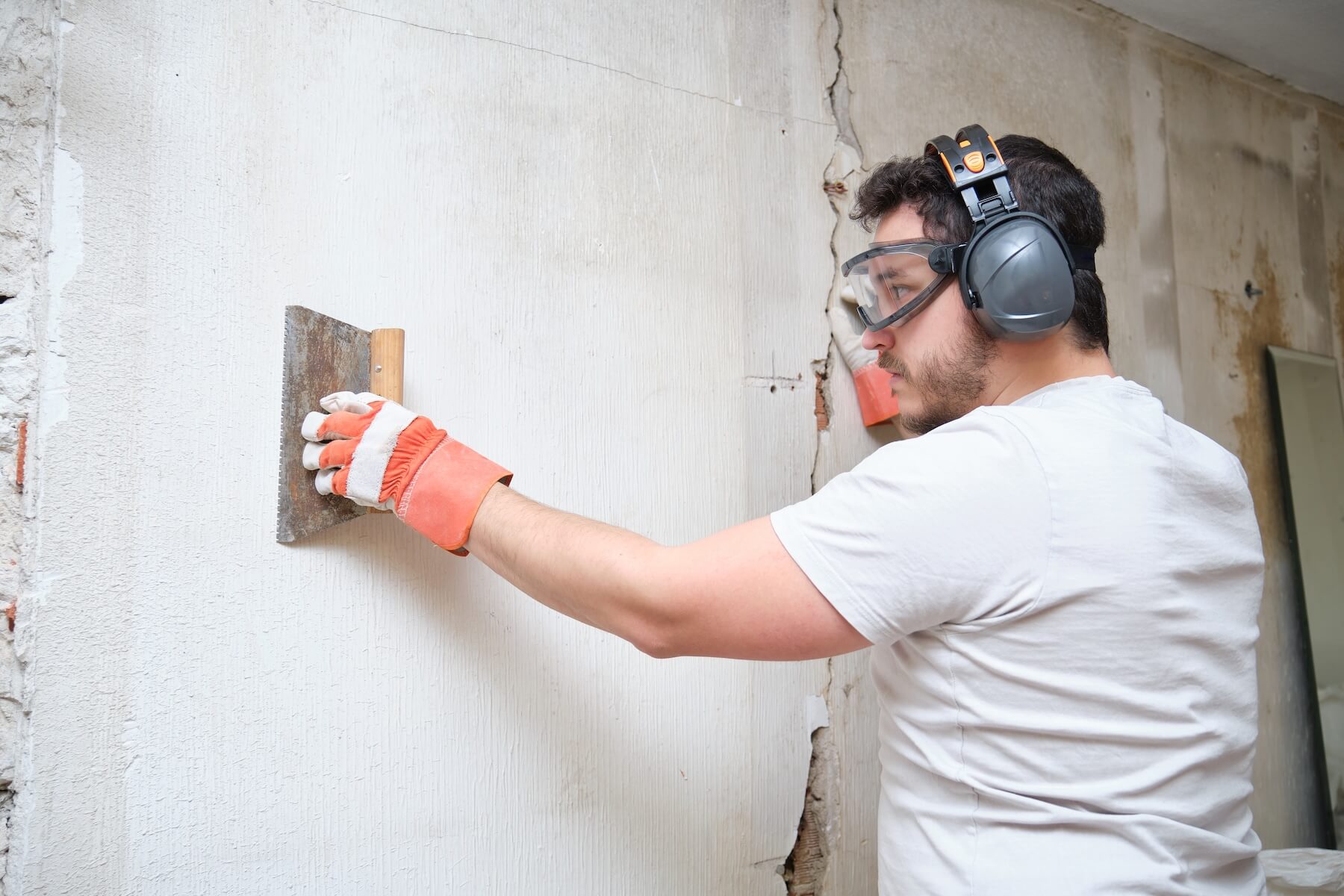 Handyman fixing a damaged wall