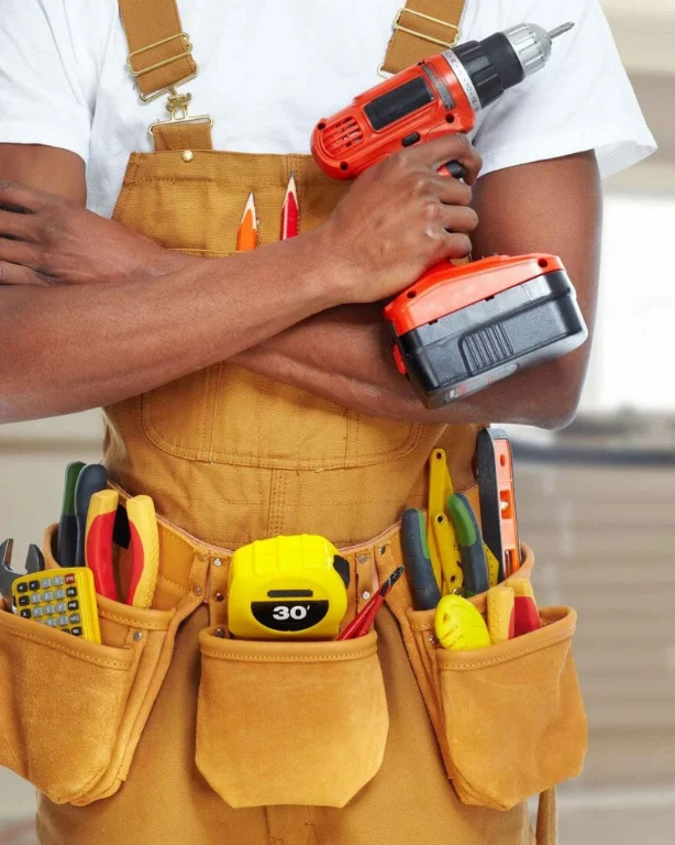 Professional handyman holding a drill and tools from Mackenzie Contracting